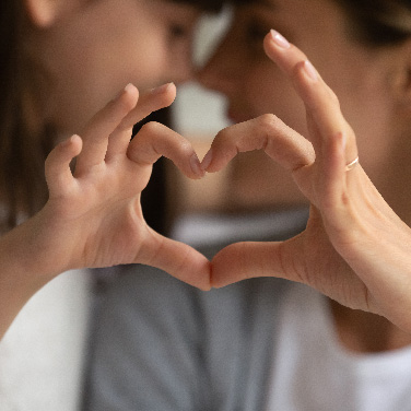 Father and daughter draw a heart with their own hands